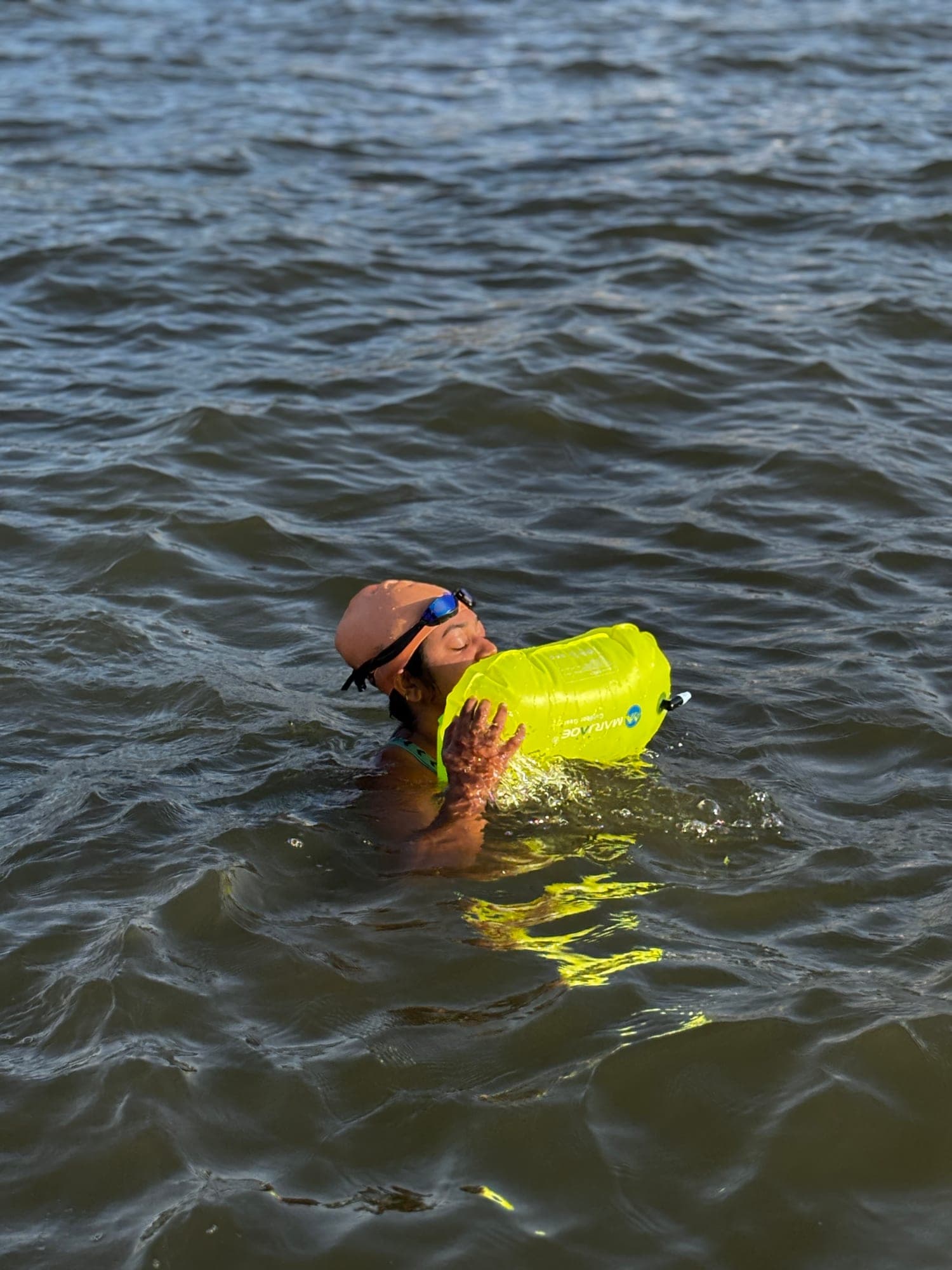 Open-water swimmer resting on a tow float