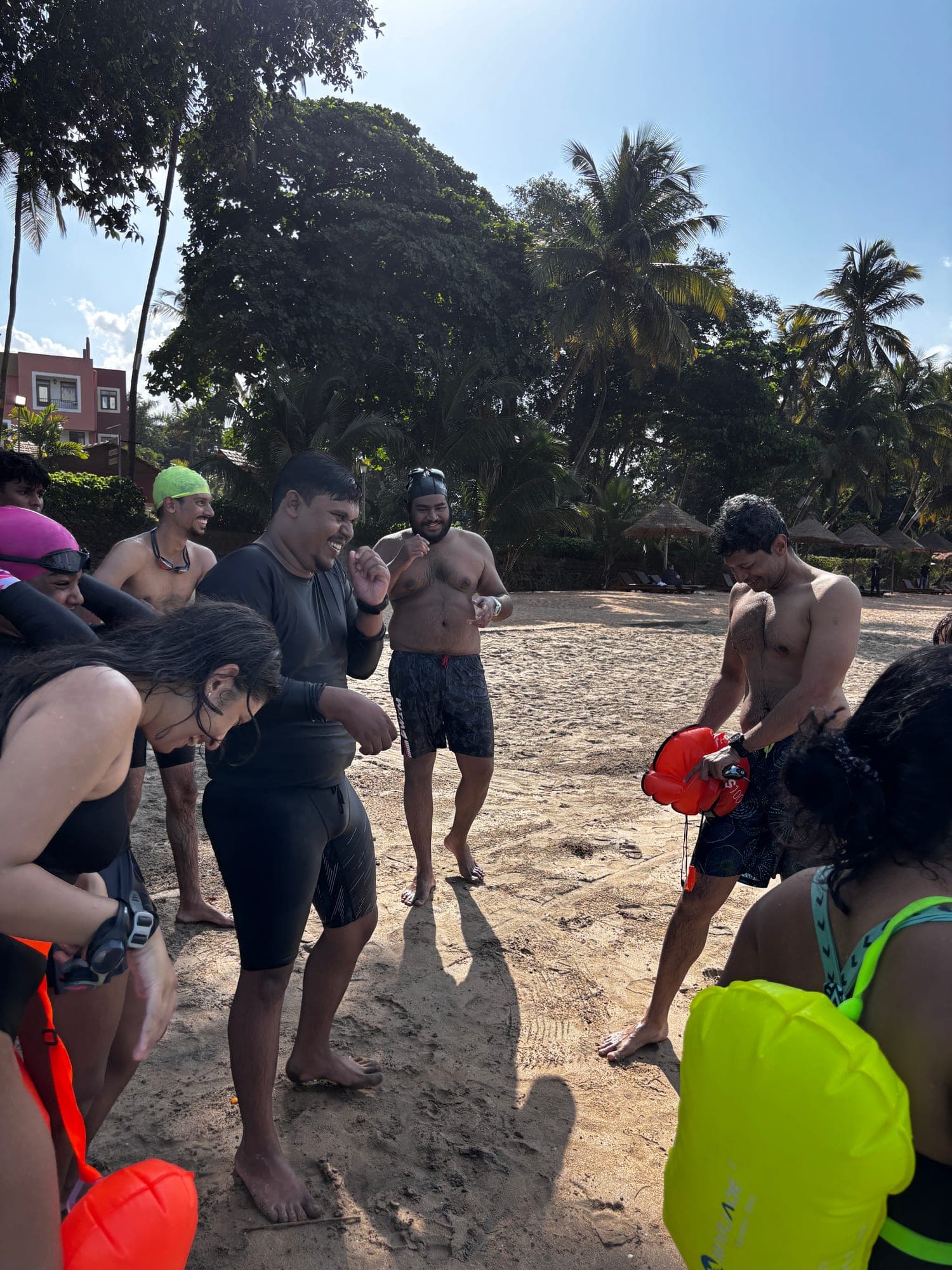 Group of swimmers laughing together on the beach