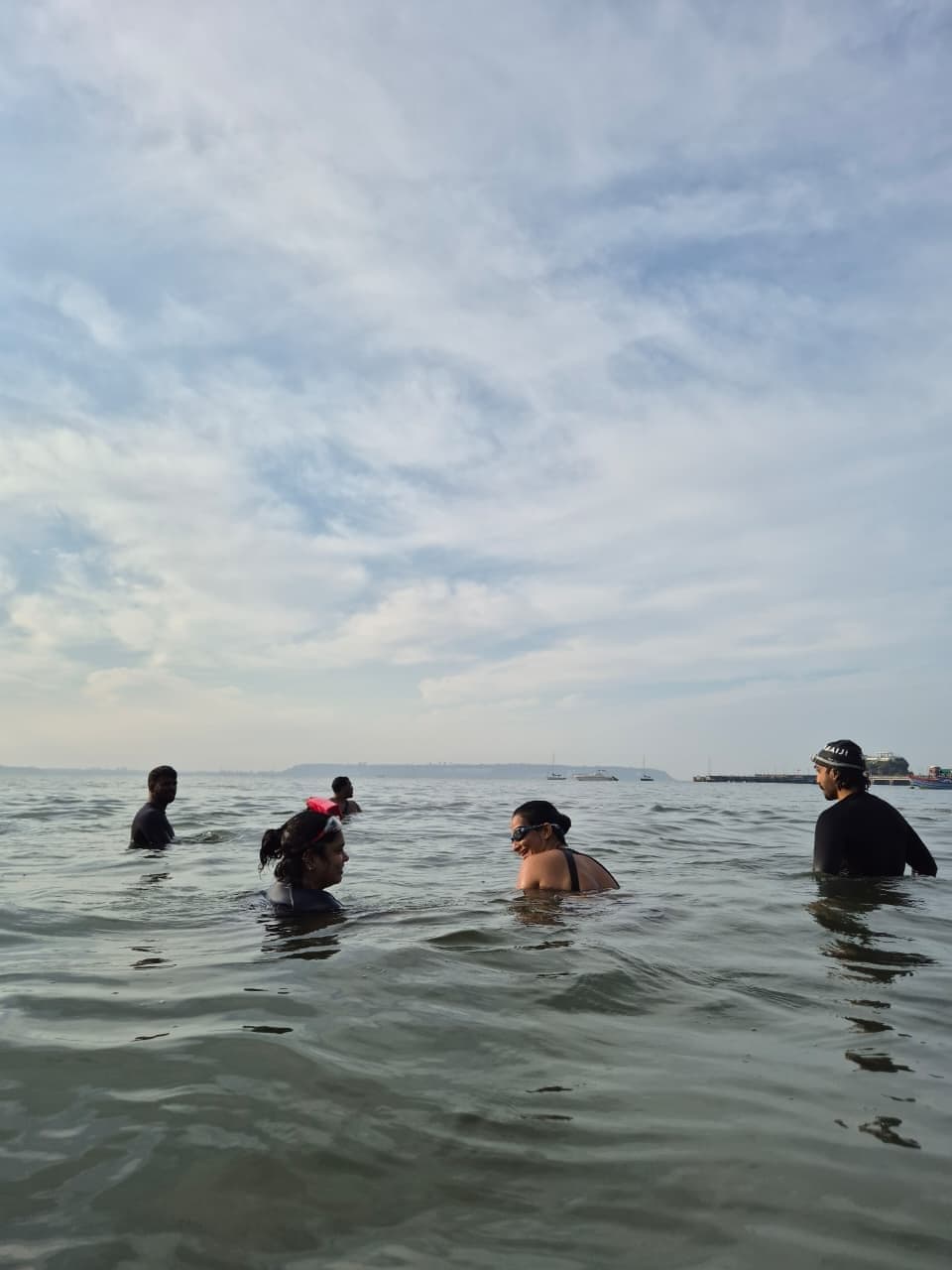 Swimmers resting and chatting in the sea at Dona Paula