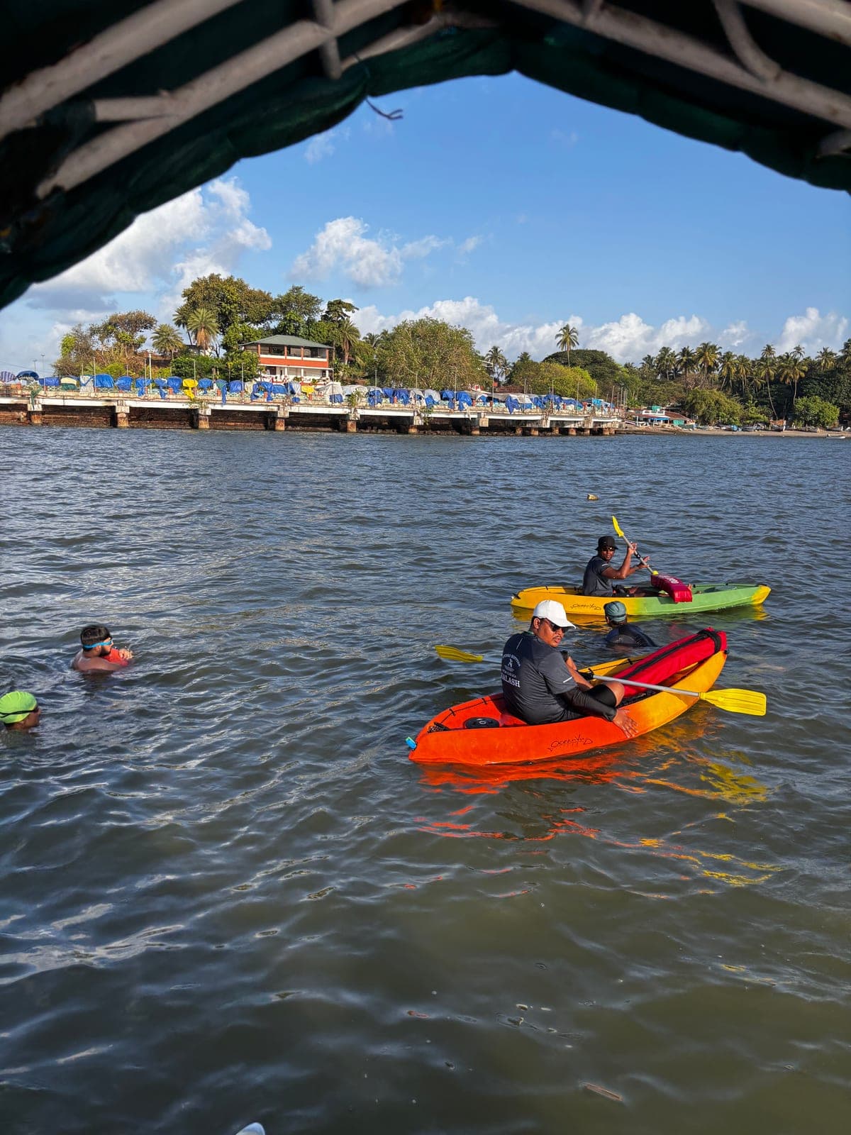 Swimmers and colourful kayaks out on the water