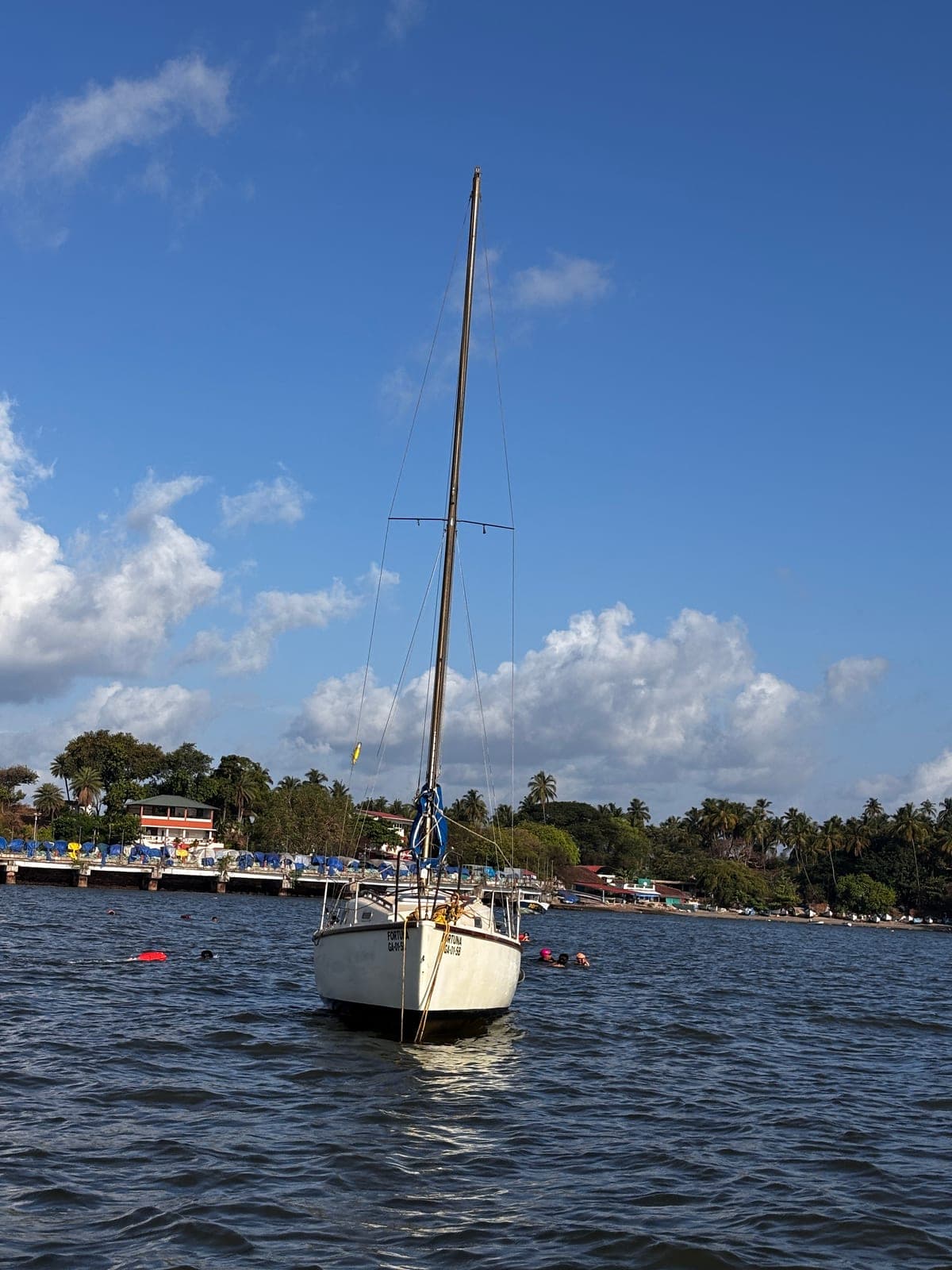 The Fortuna sailboat anchored off the jetty at Dona Paula